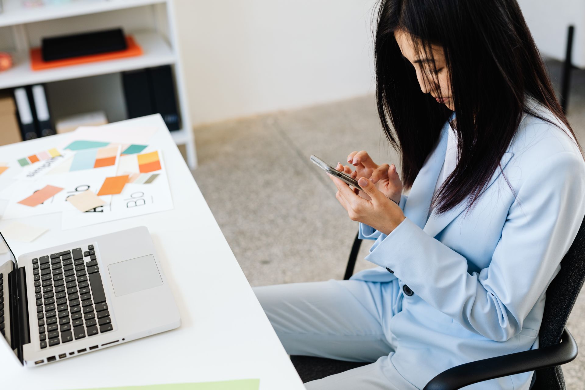 Woman using smartphone in office